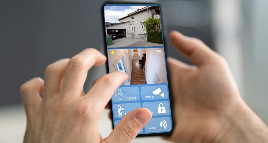 Resident examining surveillance camera feeds on a cell phone